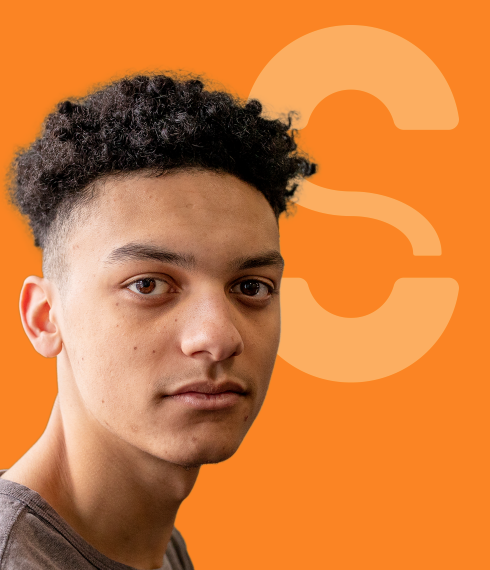 Youth looking forwards in front of orange backdrop with stylized "S"